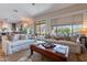 Spacious living room with large windows, hardwood floors, comfortable seating, and natural light at 3859 E Wood Dr, Chandler, AZ 85249