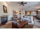 Open-concept living room features hardwood floors, a fireplace, and seamless transition to the kitchen at 3859 E Wood Dr, Chandler, AZ 85249