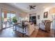 Bright living room featuring hardwood floors, large windows, a ceiling fan, and outdoor access at 3859 E Wood Dr, Chandler, AZ 85249
