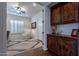 Cozy home office with wood cabinets, shutters, a ceiling fan, and a patterned rug at 3859 E Wood Dr, Chandler, AZ 85249