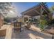 Charming outdoor patio with a pergola, comfortable seating, and well-manicured landscaping at 3859 E Wood Dr, Chandler, AZ 85249