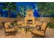 Outdoor seating area with a cozy fireplace; the perfect place to relax outdoors with friends at 3859 E Wood Dr, Chandler, AZ 85249