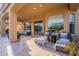 Relaxing outdoor patio featuring cushioned seating, shaded areas, and travertine pavers at 3859 E Wood Dr, Chandler, AZ 85249
