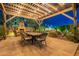 Outdoor patio with fireplace, string lights, and dining table, ideal for relaxing and entertaining at 3859 E Wood Dr, Chandler, AZ 85249
