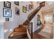 Elegant curved staircase with hardwood steps and decorative iron railing, leading to the upper level at 3859 E Wood Dr, Chandler, AZ 85249