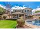 Two-story home with private pool, well-manicured lawn and landscaping in fenced backyard at 3938 E Morrison Ranch Pkwy, Gilbert, AZ 85296