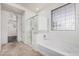 Bathroom with shower and tub combo, tile floor, and a bright window at 3938 E Morrison Ranch Pkwy, Gilbert, AZ 85296