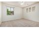 Bright bedroom with neutral carpet, ceiling fan, and large windows with backyard views at 3938 E Morrison Ranch Pkwy, Gilbert, AZ 85296