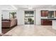 Bright dining area adjacent to the kitchen, featuring tile flooring and a view of the backyard at 3938 E Morrison Ranch Pkwy, Gilbert, AZ 85296