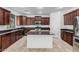 Well-equipped kitchen with dark cabinets, granite countertops, stainless steel appliances, and center island at 3938 E Morrison Ranch Pkwy, Gilbert, AZ 85296