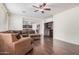 Spacious living room featuring a brown sectional sofa, dark wood floors, and a built-in cabinet at 3938 E Morrison Ranch Pkwy, Gilbert, AZ 85296
