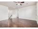 Spacious living room featuring hardwood floors, a ceiling fan, and a staircase at 3938 E Morrison Ranch Pkwy, Gilbert, AZ 85296
