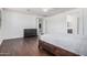 Bright main bedroom with hardwood floors, a large bed, and neutral decor at 3938 E Morrison Ranch Pkwy, Gilbert, AZ 85296