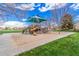 Community playground with slides, climbing structures, and swings, surrounded by sand and green space at 3938 E Morrison Ranch Pkwy, Gilbert, AZ 85296