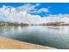 Scenic view of a community pond with waterfront views, landscaping, and surrounding neighborhood buildings at 3938 E Morrison Ranch Pkwy, Gilbert, AZ 85296