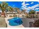 Sparkling blue pool surrounded by lush landscaping and desert trees, creating a private oasis at 3938 E Morrison Ranch Pkwy, Gilbert, AZ 85296