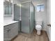 Bathroom featuring a glass shower, vanity with sink, and commode at 4237 E Clovis Ave, Mesa, AZ 85206