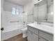 Clean and functional bathroom with a shower-tub combo, neutral finishes, and ample vanity storage at 4237 E Clovis Ave, Mesa, AZ 85206