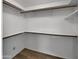 Large walk-in closet with built-in shelving and laminate wood flooring at 4237 E Clovis Ave, Mesa, AZ 85206