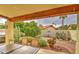 Relaxing covered back patio with a grill and view of the desert landscaped backyard with citrus trees and cacti at 542 S Higley Rd # 102, Mesa, AZ 85206