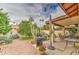 Inviting backyard space featuring desert landscaping, covered patio, dining set, and BBQ grill at 542 S Higley Rd # 102, Mesa, AZ 85206