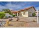 Landscaped front yard with mature plants, rocks, and a charming single-story home at 542 S Higley Rd # 102, Mesa, AZ 85206