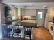 Bright kitchen with granite countertops, white cabinets, and bar seating for entertaining at 542 S Higley Rd # 102, Mesa, AZ 85206