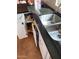 Kitchen featuring stainless steel sink, granite countertops and white cabinetry with pull out shelves for storage at 542 S Higley Rd # 102, Mesa, AZ 85206