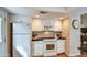 The kitchen has white appliances and cabinets and black granite countertops at 542 S Higley Rd # 102, Mesa, AZ 85206
