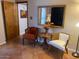 Sitting area with chairs, small table, decorative mirror, and tile flooring near the entryway at 542 S Higley Rd # 102, Mesa, AZ 85206