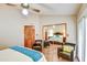 Spacious main bedroom boasts mirrored closet doors, ceiling fan, and relaxing seating area at 542 S Higley Rd # 102, Mesa, AZ 85206
