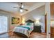 Bright, airy main bedroom featuring tile floors, a ceiling fan, and private outdoor access to covered patio at 542 S Higley Rd # 102, Mesa, AZ 85206