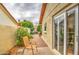 Relaxing outdoor patio with a comfortable chair, small table, and garden views at 542 S Higley Rd # 102, Mesa, AZ 85206