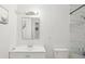 Clean, bright bathroom with marble-look tiled shower, white fixtures, and modern design at 6541 N 41St Ave, Phoenix, AZ 85019