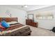 Comfortable bedroom featuring natural light, dresser with mirror, carpeted floor and a bright atmosphere at 6541 N 41St Ave, Phoenix, AZ 85019