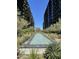 Relaxing water feature with lush landscaping and towering modern buildings on either side at 7120 E Kierland Blvd # 211, Scottsdale, AZ 85254