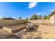 Inviting backyard featuring a stylish outdoor dining area, raised garden bed, and ample space for entertaining under the blue sky at 7215 W Union Hills Dr, Glendale, AZ 85308