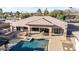 Backyard oasis features a sparkling pool, a spacious patio area, and a lush lawn perfect for relaxation and outdoor entertaining at 7215 W Union Hills Dr, Glendale, AZ 85308