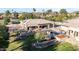 Expansive backyard featuring a refreshing pool, a cozy pergola, lush green landscaping, and ample space for outdoor activities at 7215 W Union Hills Dr, Glendale, AZ 85308