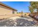 Spacious backyard showcasing a basketball court, gravel landscaping, and ample room for outdoor activities at 7215 W Union Hills Dr, Glendale, AZ 85308