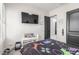 Well-lit bedroom featuring a large TV, themed decor, and convenient access to an ensuite bathroom at 7215 W Union Hills Dr, Glendale, AZ 85308