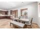 Bright dining area with a long table and adjacent kitchen at 7215 W Union Hills Dr, Glendale, AZ 85308