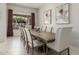 Elegant dining room features a long table with seating for ten and large windows at 7215 W Union Hills Dr, Glendale, AZ 85308