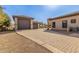 Paver driveway leading to garages with stone accents and a well-maintained landscape at 7215 W Union Hills Dr, Glendale, AZ 85308