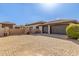 Large brick driveway leading to a home with two garage spaces and beautiful stonework at 7215 W Union Hills Dr, Glendale, AZ 85308