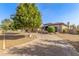 Inviting circular brick driveway leading to a well-manicured home with mature landscaping at 7215 W Union Hills Dr, Glendale, AZ 85308