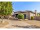 Charming home featuring an arched entrance, manicured bushes, and beautiful masonry accents at 7215 W Union Hills Dr, Glendale, AZ 85308