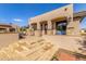 Charming home exterior with stone accents, arched doorways, and a welcoming patio, blending elegance and curb appeal at 7215 W Union Hills Dr, Glendale, AZ 85308