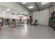 Spacious garage with high ceilings, multiple garage doors, and ample room for storage and recreation at 7215 W Union Hills Dr, Glendale, AZ 85308