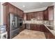 Modern kitchen with stainless steel appliances, granite countertops, and dark wood cabinetry at 7215 W Union Hills Dr, Glendale, AZ 85308